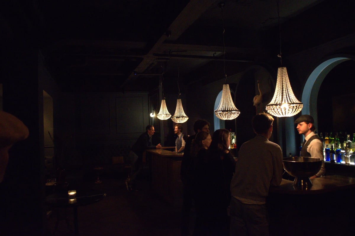Private cocktail bar in use during a business event at Le Flamant Bleu with guests and bartender interaction